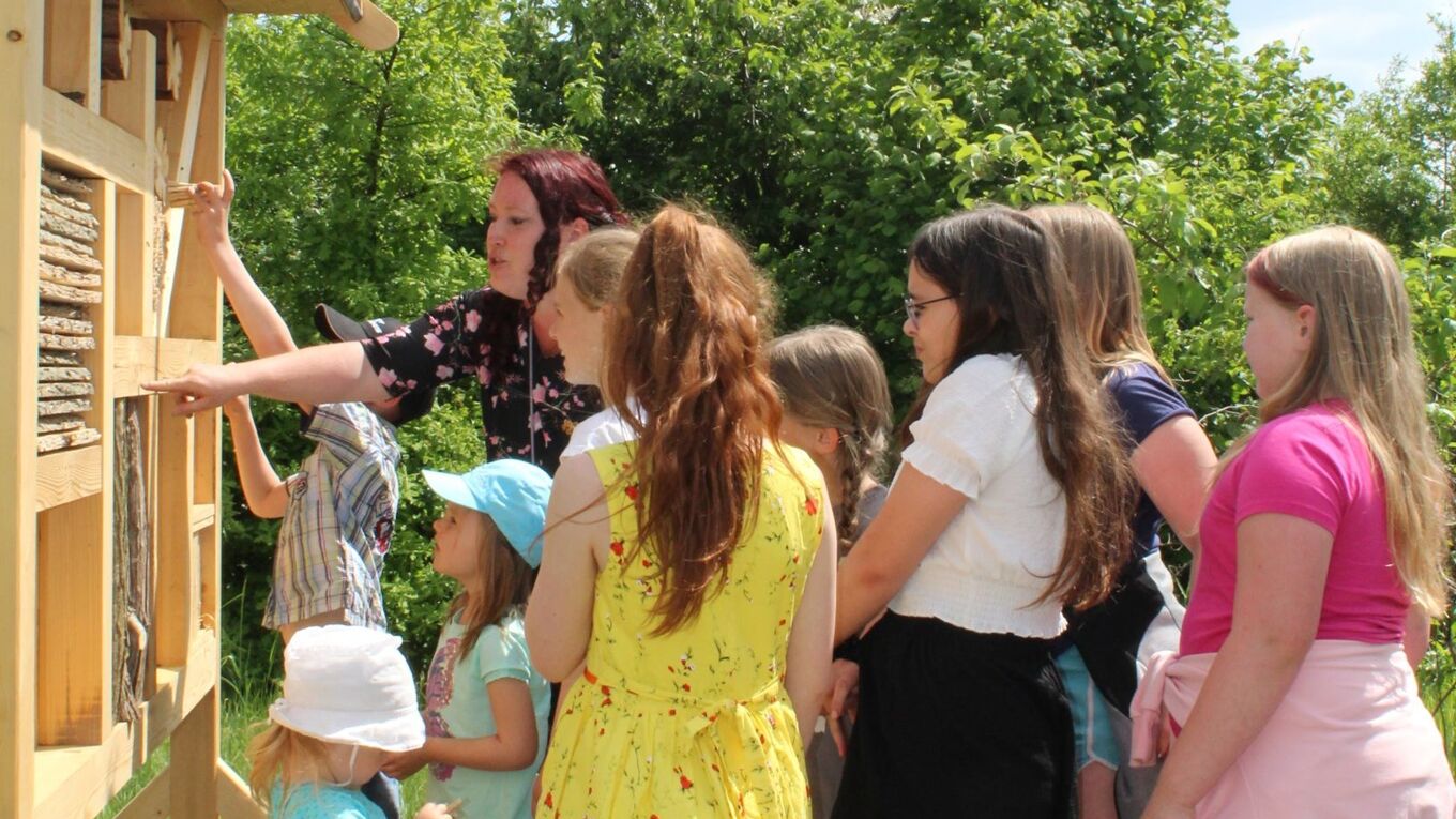Kindergruppe vor einem Insektenhotel anlässlich der Einweihung des Artenvielfaltsprojekts im Kleingarten Dommitzsch am 14.05.2022